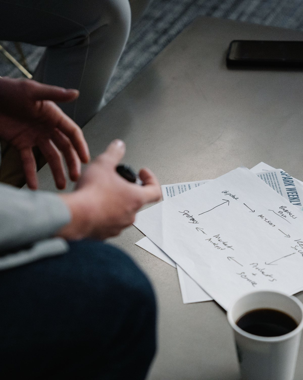 A marketer reviewing plans and notes at a desk