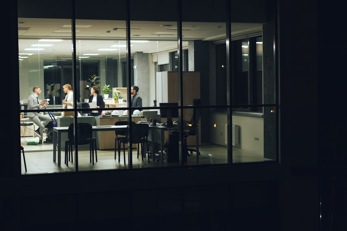 An office meeting room seen through glass at night
